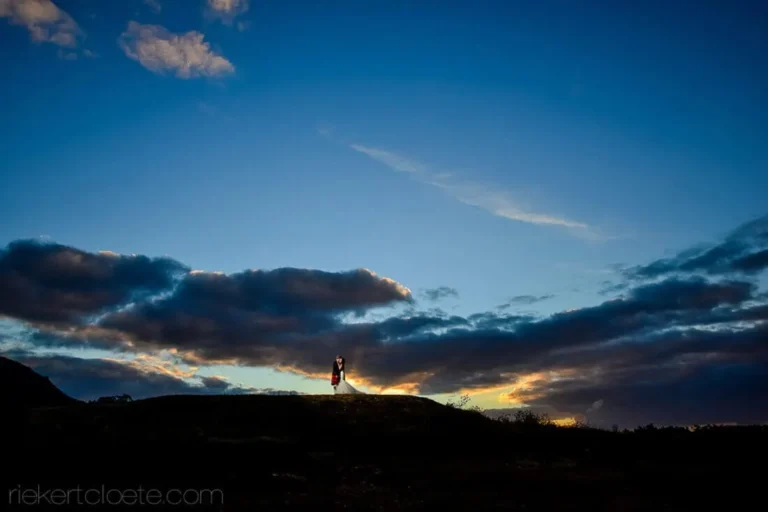 couple silhouette dramatic blue sky clouds