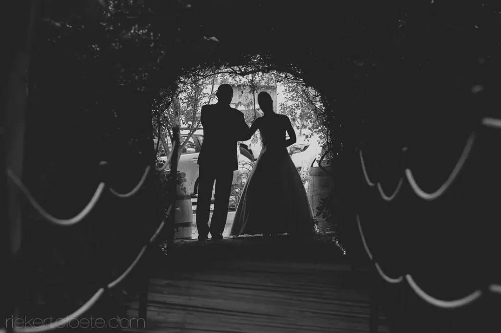 couple silhouette floral arch black white