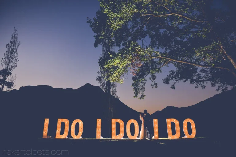 couple silhouette glowing i do letters mountain dusk
