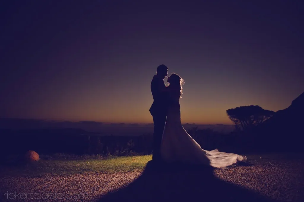 couple silhouette gravel path sunset mountain view