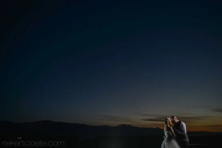 couple silhouette vast dark sky mountain landscape