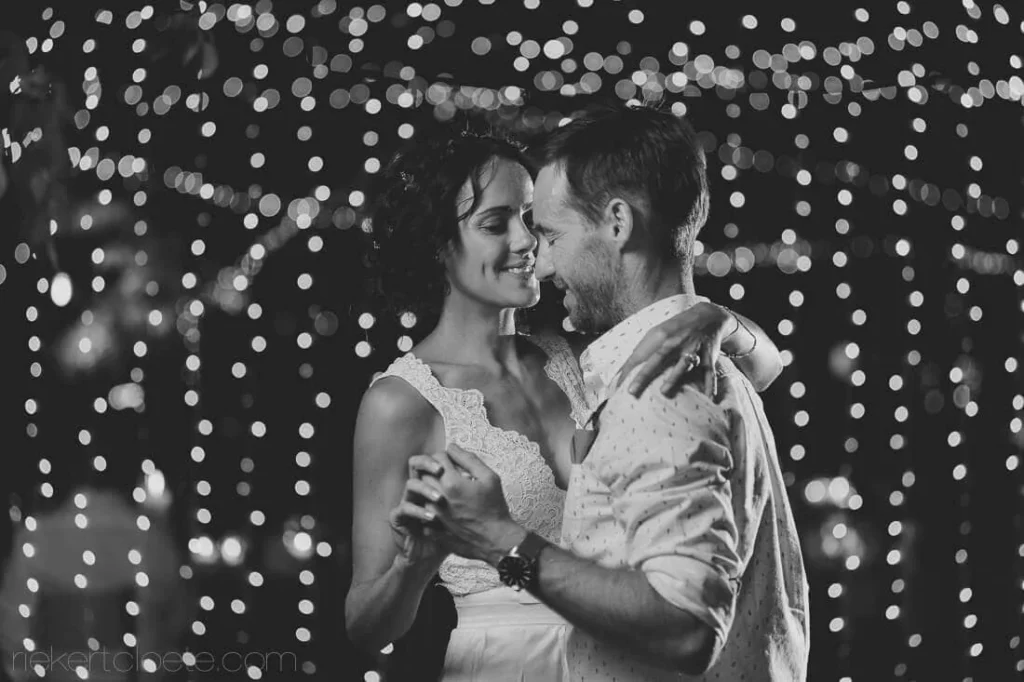 couple slow dance bokeh fairy lights reception