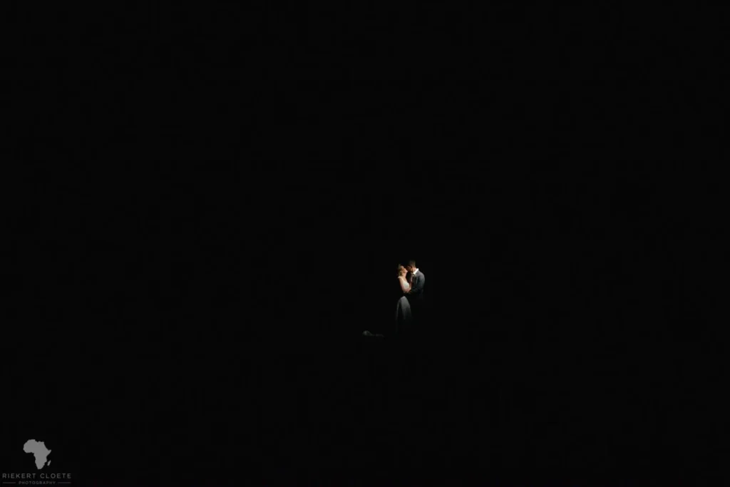 couple spotlight complete darkness dramatic night