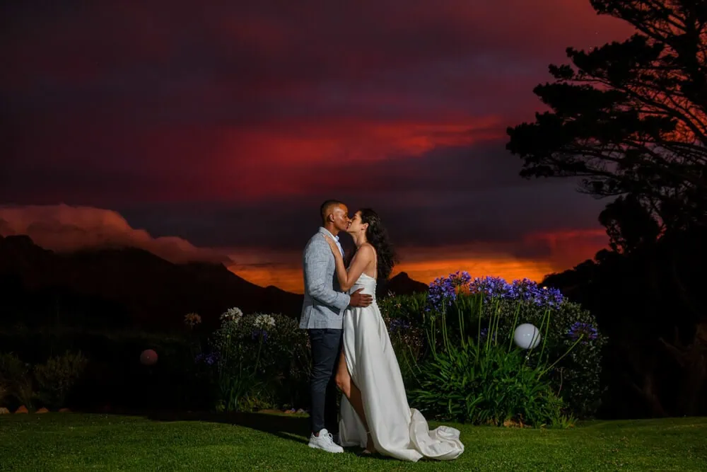 couple suikerbossie red sunset mountain kiss