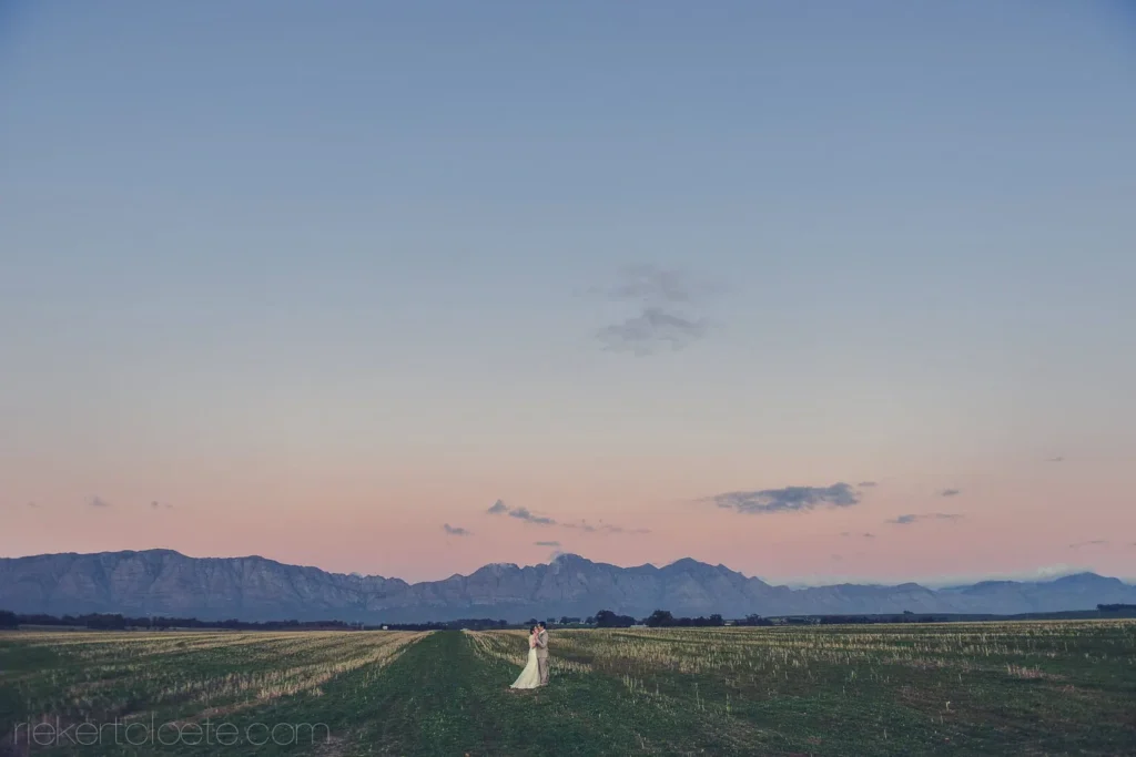 couple twilight grain field mountain silhouette