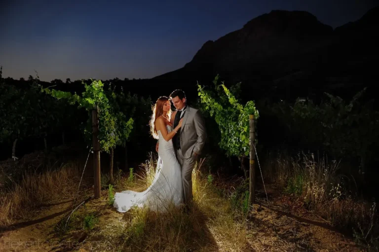 couple vineyard dusk mountain silhouette winelands