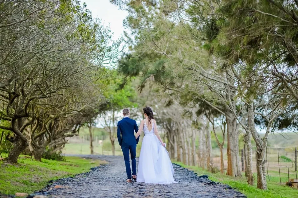 couple walking cobbled tree lined estate avenue