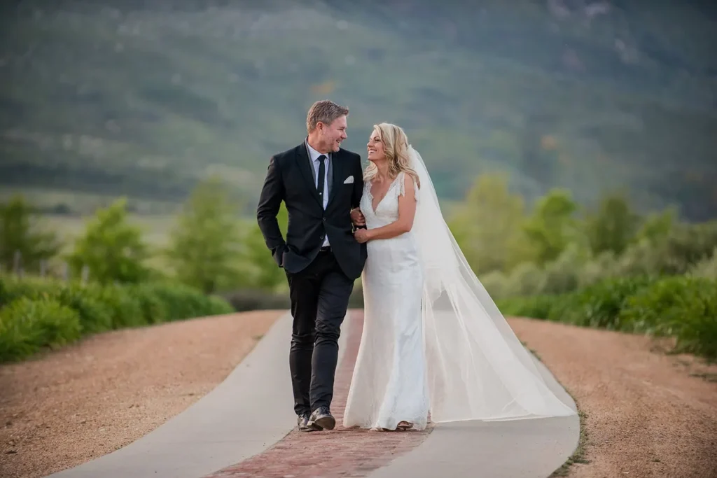 couple walking estate road mountain backdrop