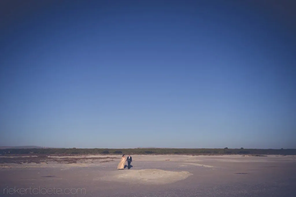 couple walking flat coastal beach west coast