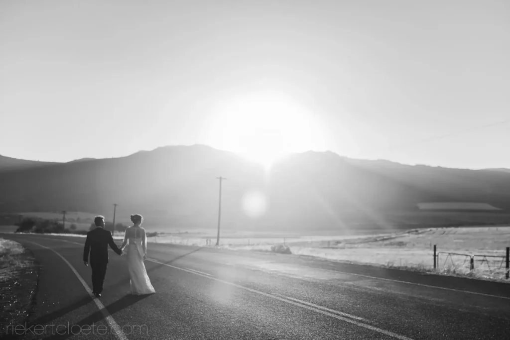 couple walking mountain road black white