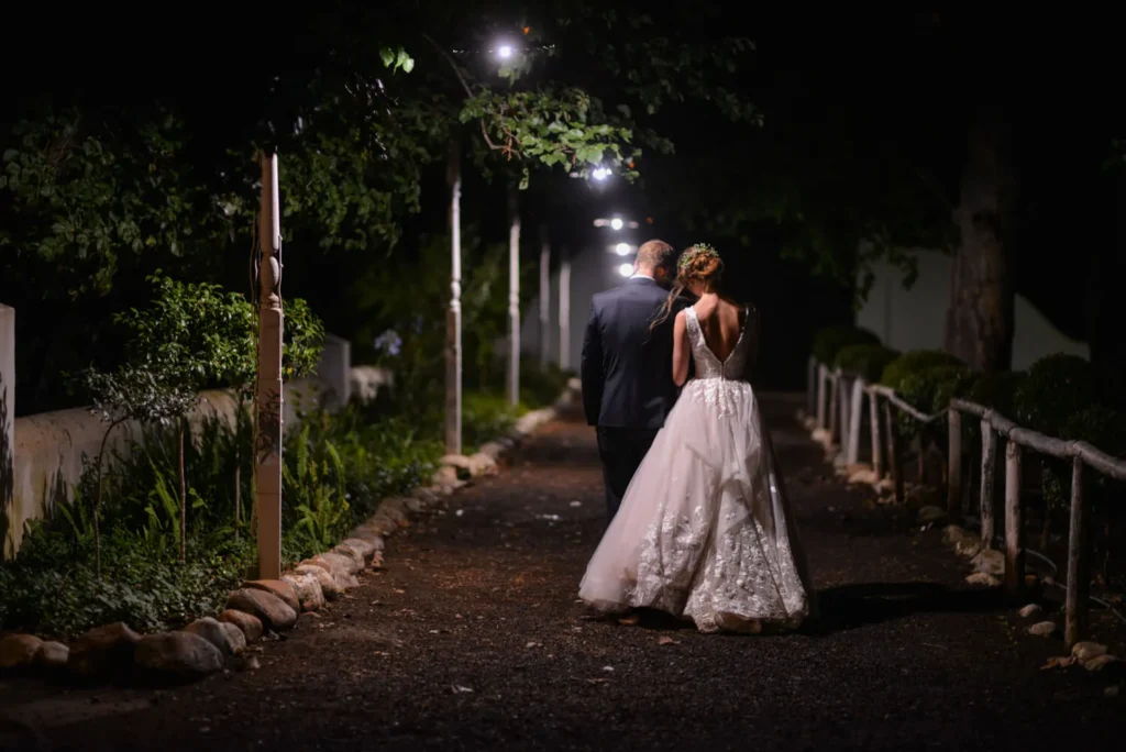 couple walking night lit path estate entrance