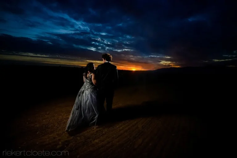 couple watching fiery sunset open rocky landscape