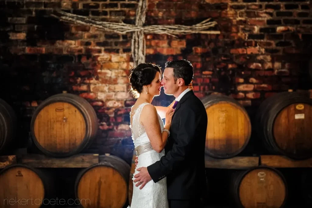 couple wine cellar oak barrels nightshot portrait