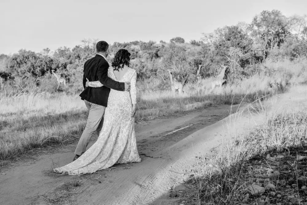 destination wedding couple dirt road black white