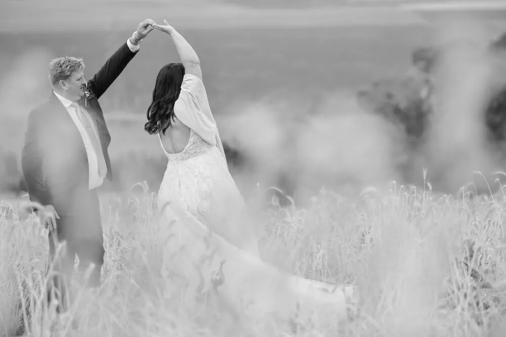 durbanville groom twirling bride golden wheat field