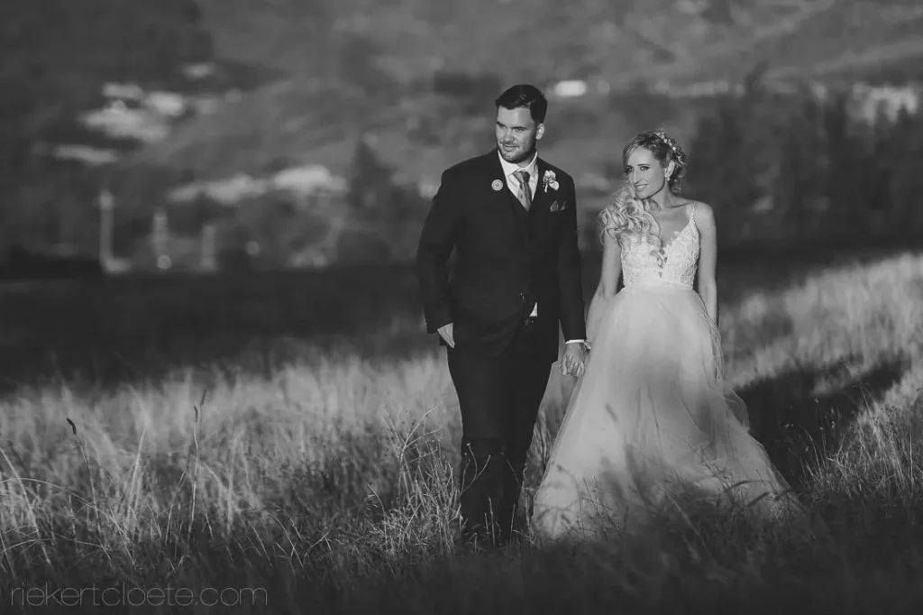 elegant couple walking golden grass black white