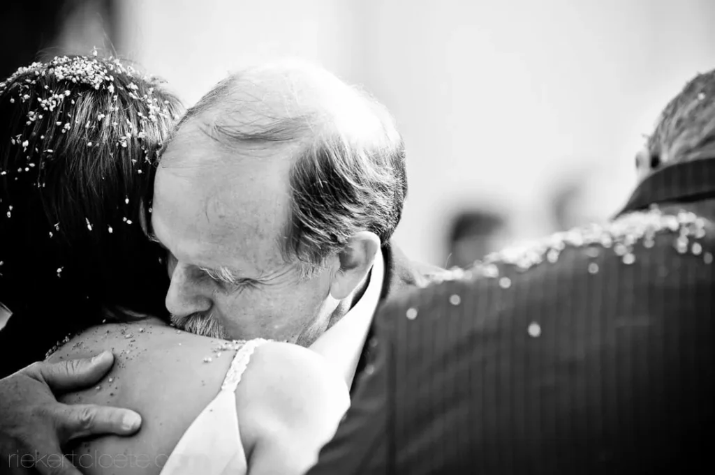 father emotional close embrace bride after ceremony