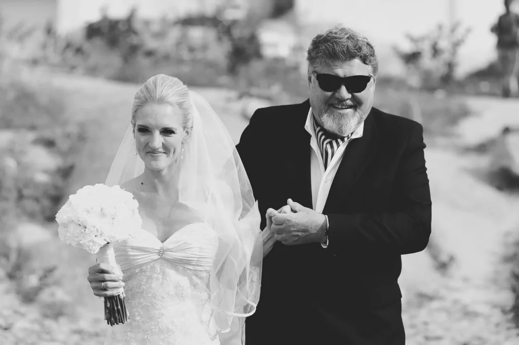 father sunglasses escorting bride outdoor ceremony