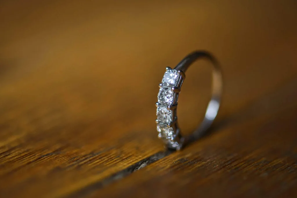 five diamond cluster eternity band wooden surface