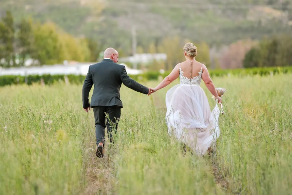 franschhoek wedding couple running green field