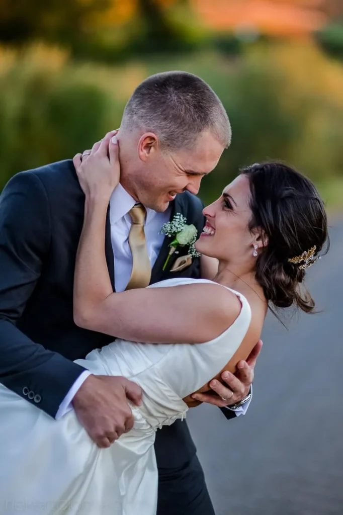 groom dipping bride romantic golden sunset