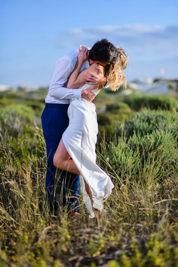 groom dipping bride romantic kiss coastal fynbos