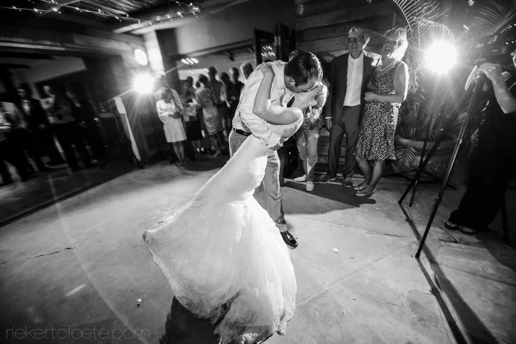 groom dramatic dip bride outdoor reception low angle