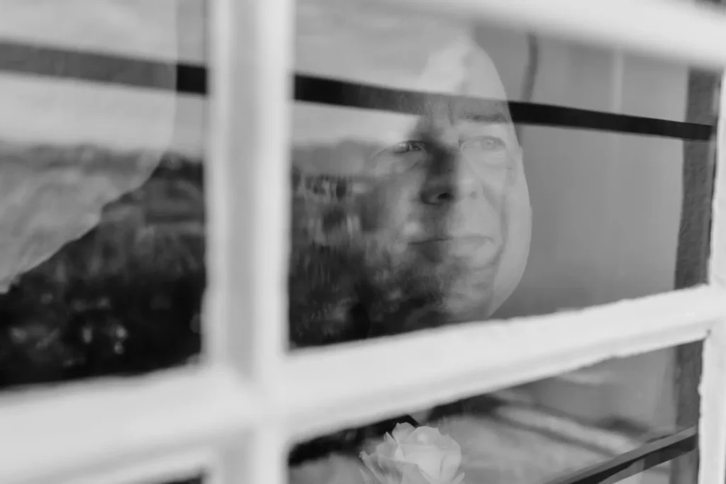 groom face window reflection black white