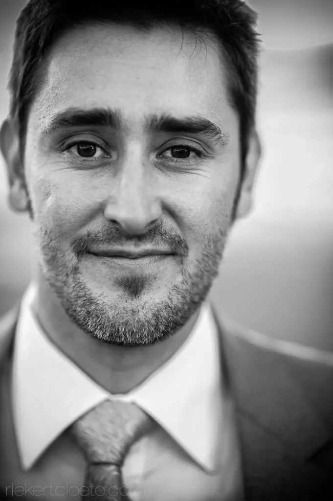 groom grey suit soft focus close portrait bw