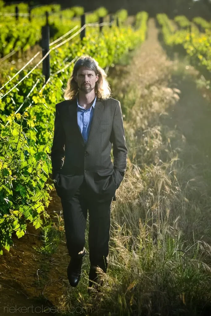 groom grey suit vineyard golden hour portrait