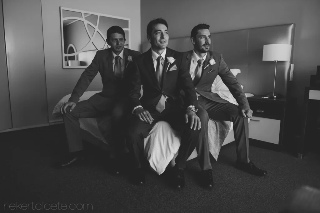 groom groomsmen getting ready hotel room