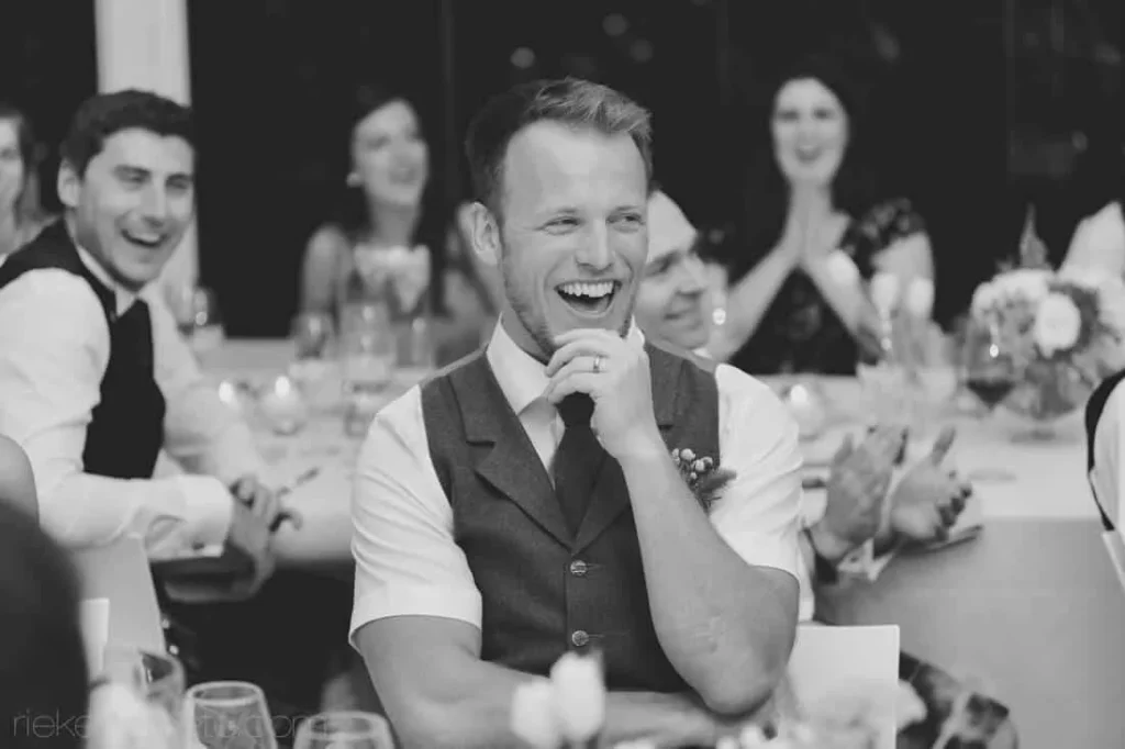 groom laughing speech moment wedding reception