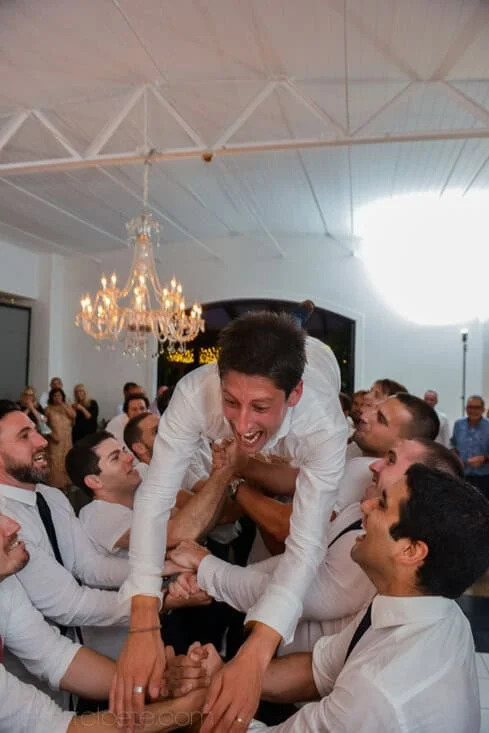 groom lifted groomsmen wedding reception celebration