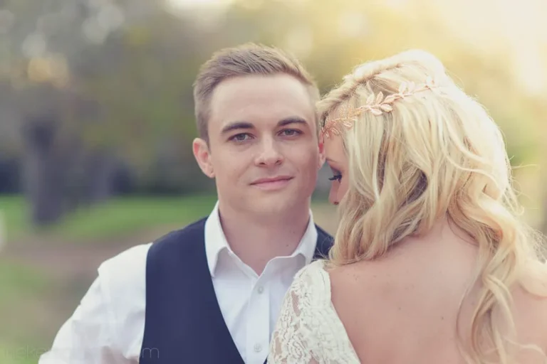 groom looking camera bride leaning shoulder portrait