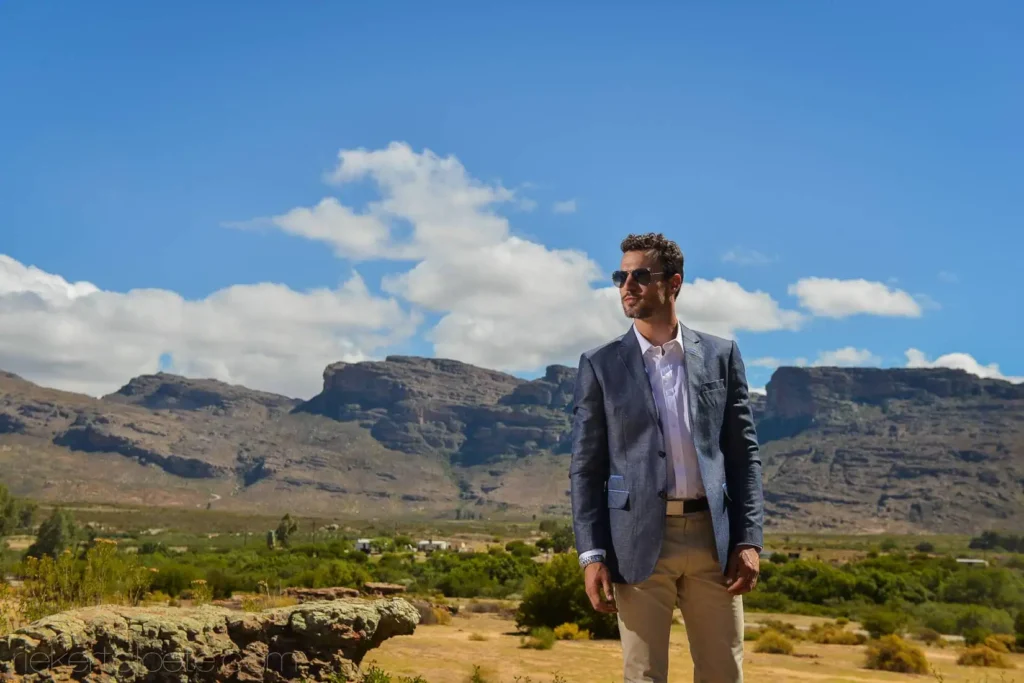 groom navy blazer sunglasses mountain landscape
