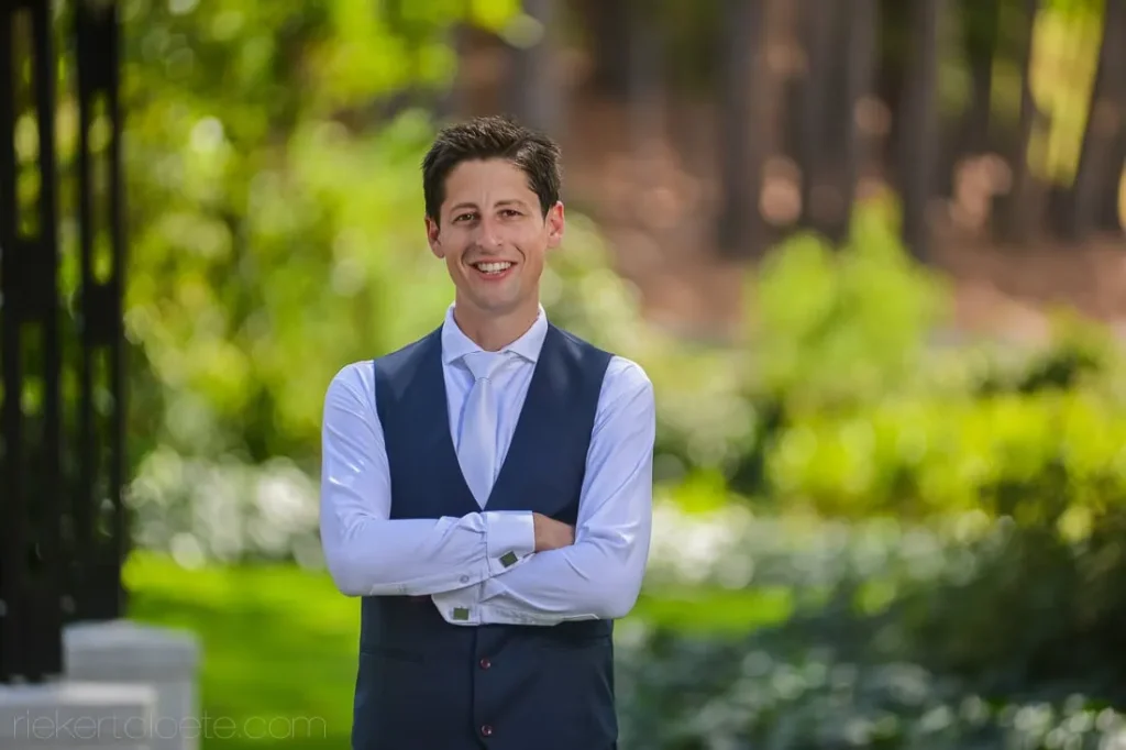 groom navy vest grey tie arms crossed garden v1