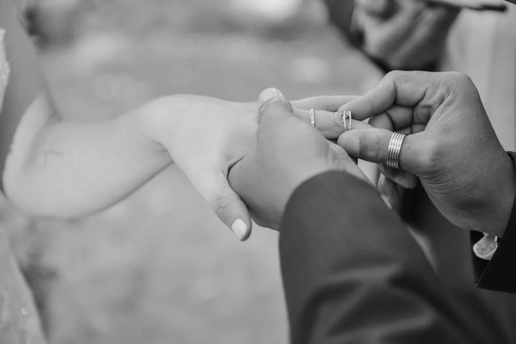 groom placing ring on bride finger ceremony
