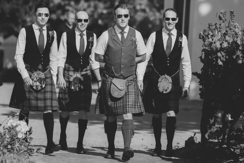groomsmen kilts waistcoats walking together