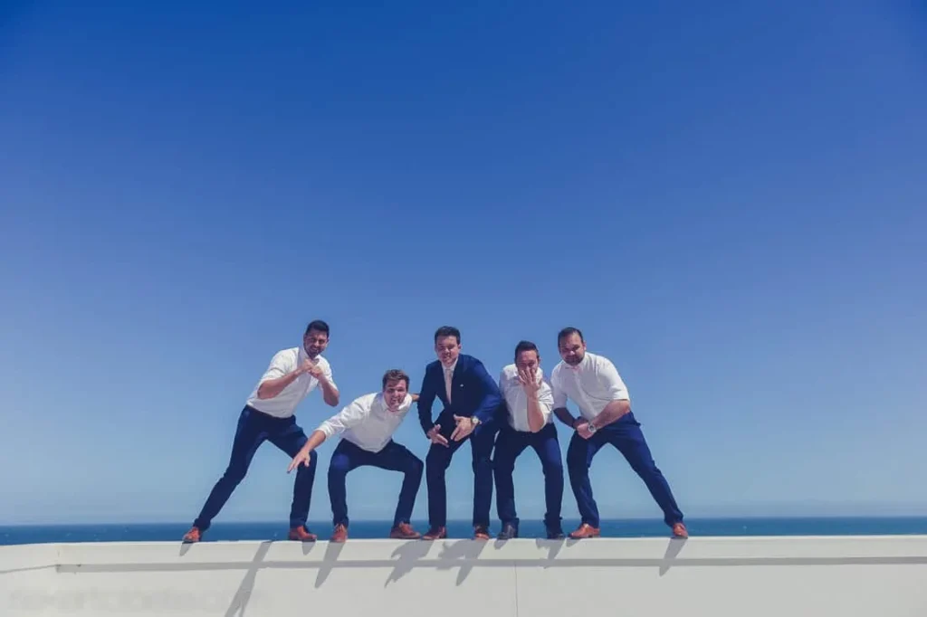 groomsmen white shirts rooftop ocean view