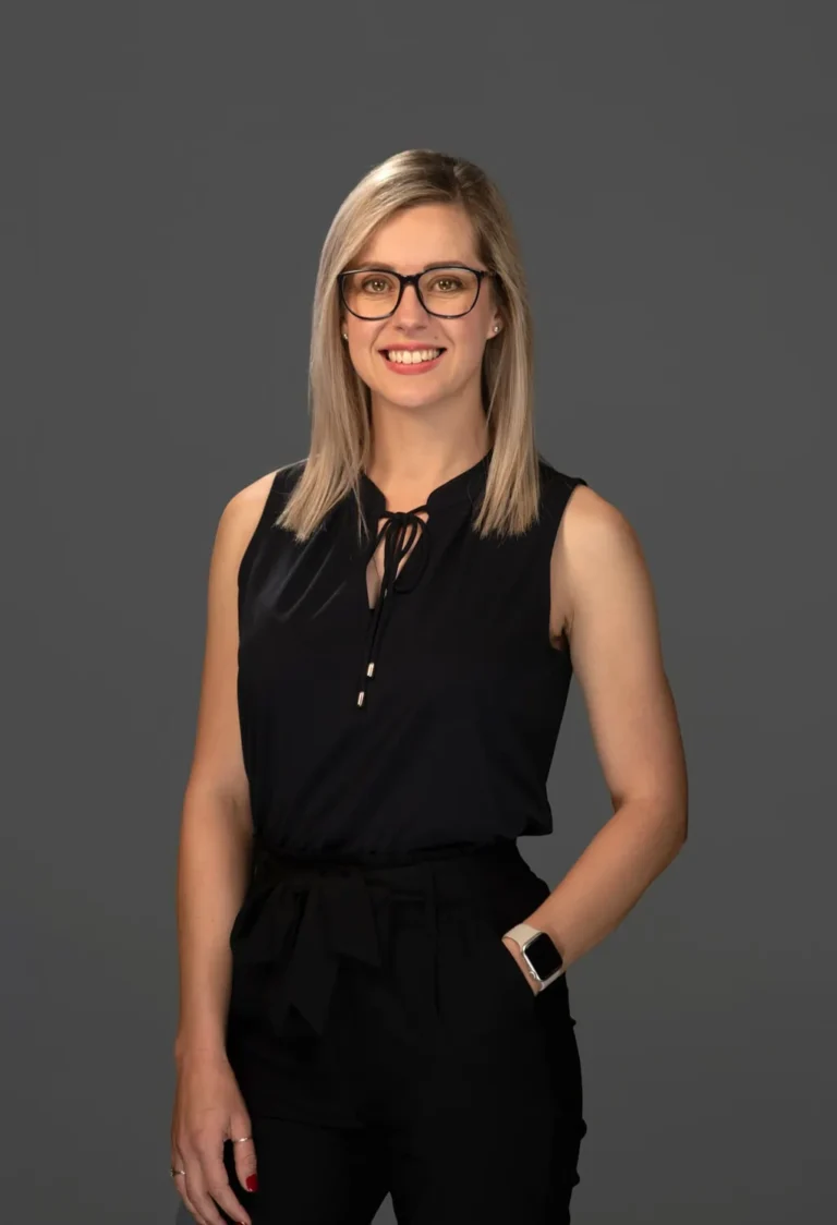 Woman, professional smile, on a dark grey backdrop