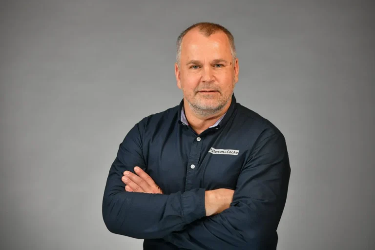 Man, professional confident, on a grey backdrop