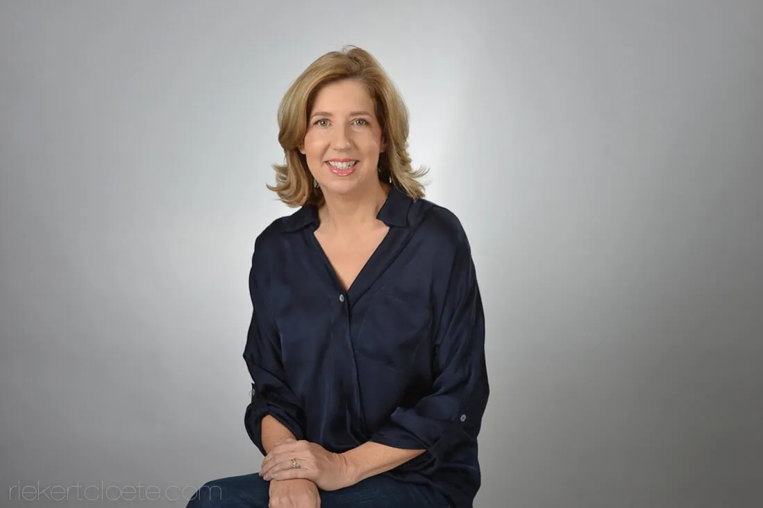 headshot photographer cape town grey background horizontal 10 woman warm smile