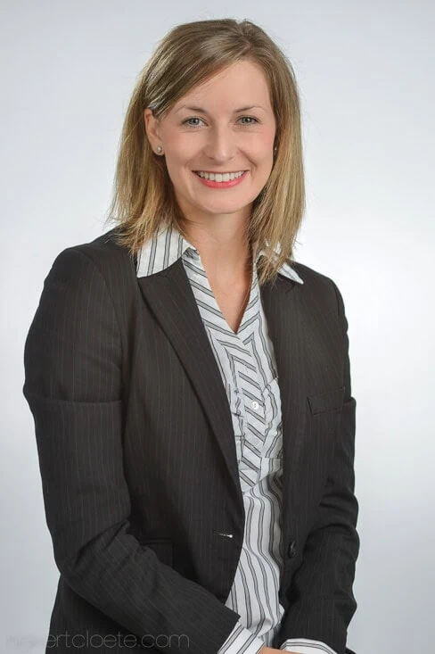 Woman, professional smile, on a light grey backdrop