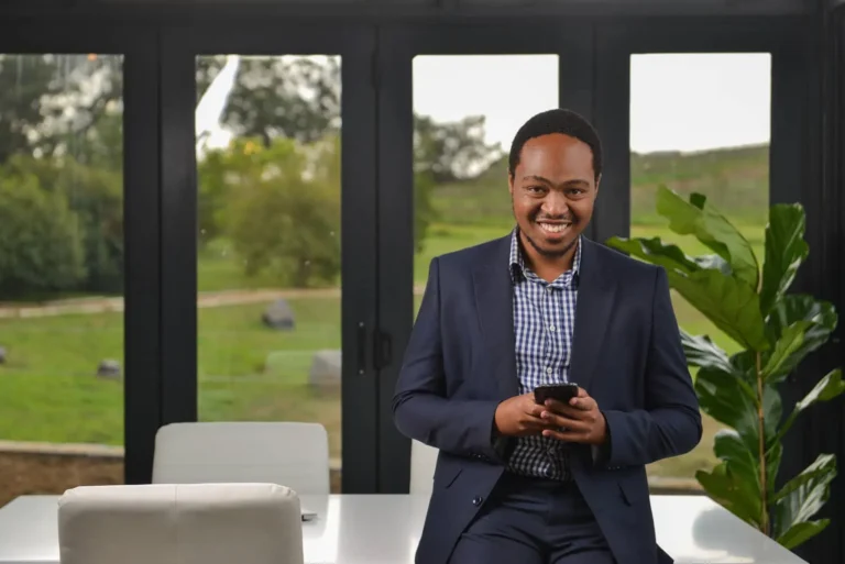 Man, confident smile, in the workplace