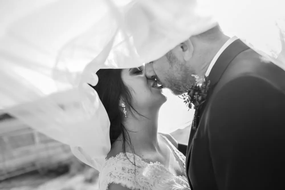 passionate kiss flowing veil close up portrait bw