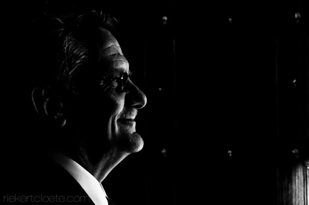 proud father dramatic side lit wedding portrait