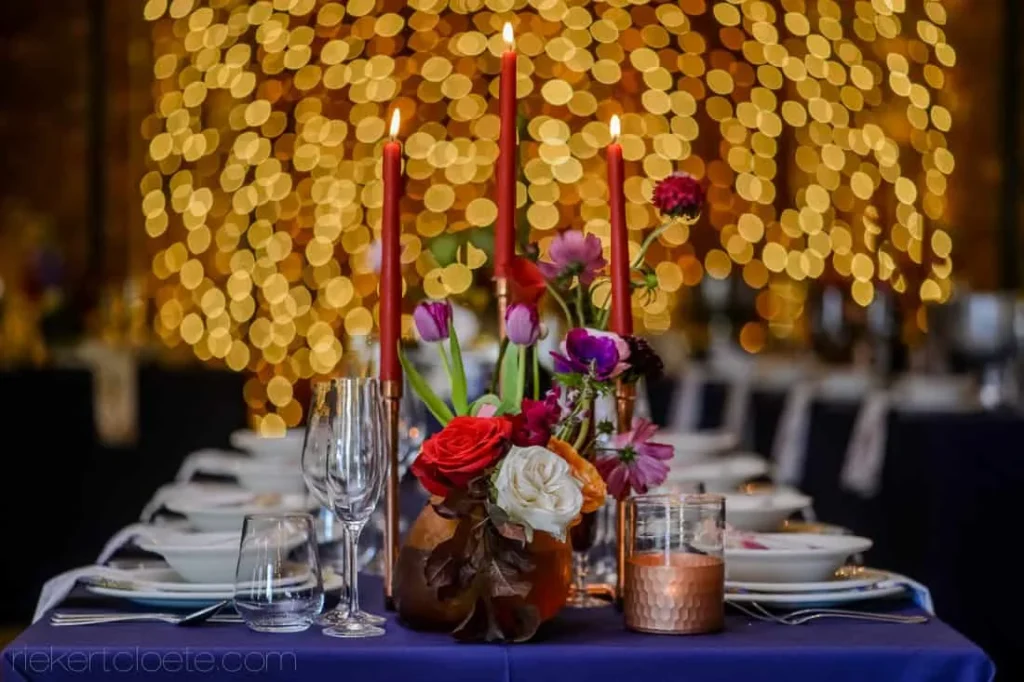 red candles colorful floral blue tablecloth reception