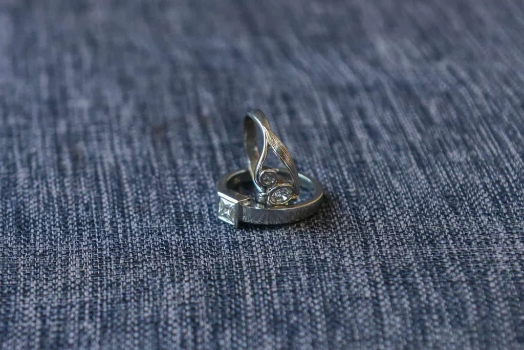 silver wedding rings grey denim fabric detail