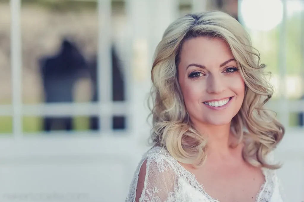 smiling bride lace dress horse stable portrait