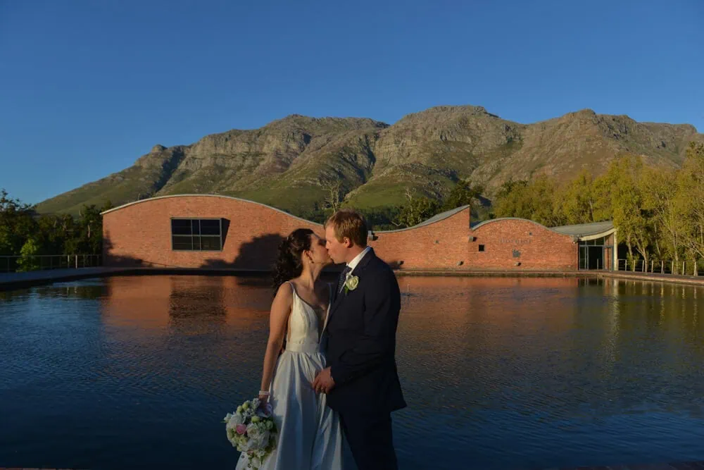 stellenbosch couple kissing reflective pool mountains
